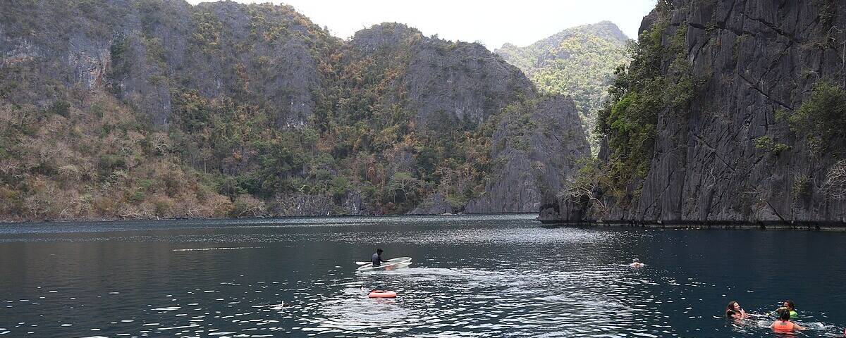Crystal-clear water and limestone formations inside Barracuda Lake, Coron Island