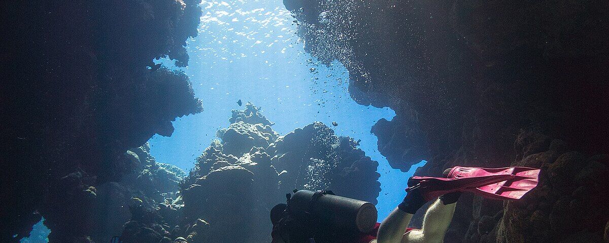 Light shaft streaming through the Cathedral Cave chimney at Pescador Island, Moalboal